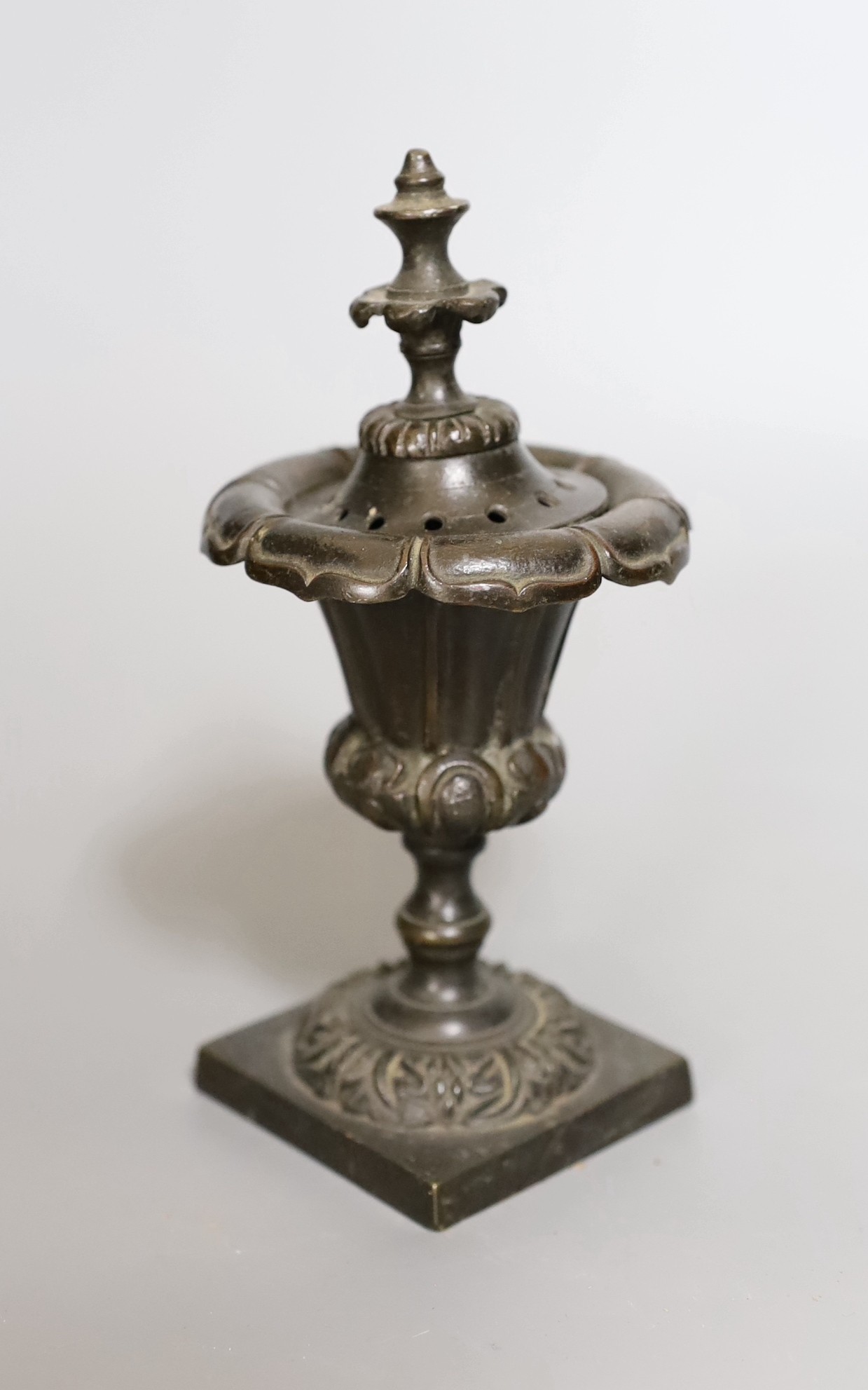 A Victorian copper vase on plinth base, a pair of Victorian cast iron recumbent dog door stops and a Regency bronze censer and cover, and a Victorian lacquered bellow (5)